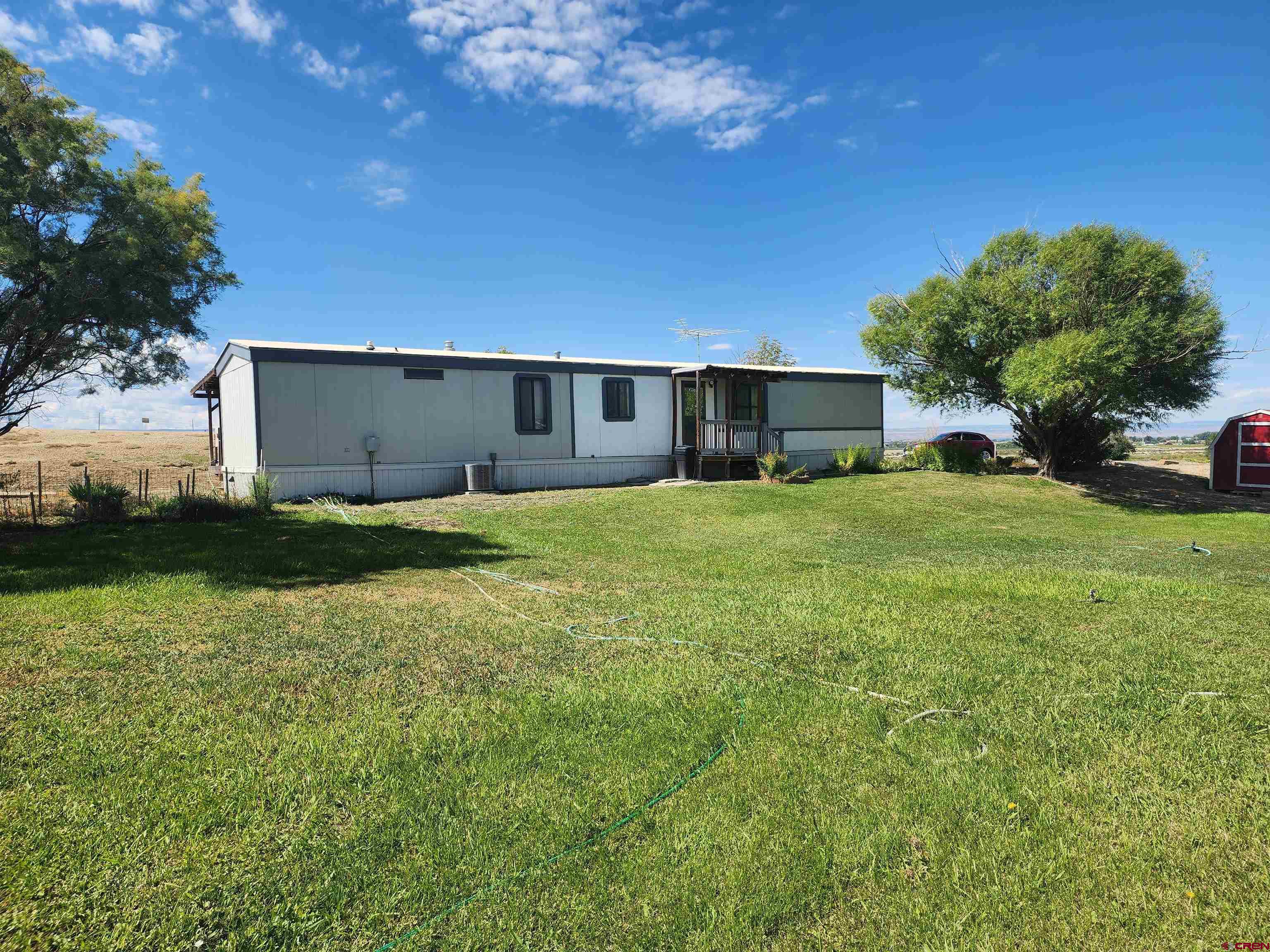 5280 6200th Road Olathe, CO 81425 - Photo 22 of 22 a view of a house with a yard