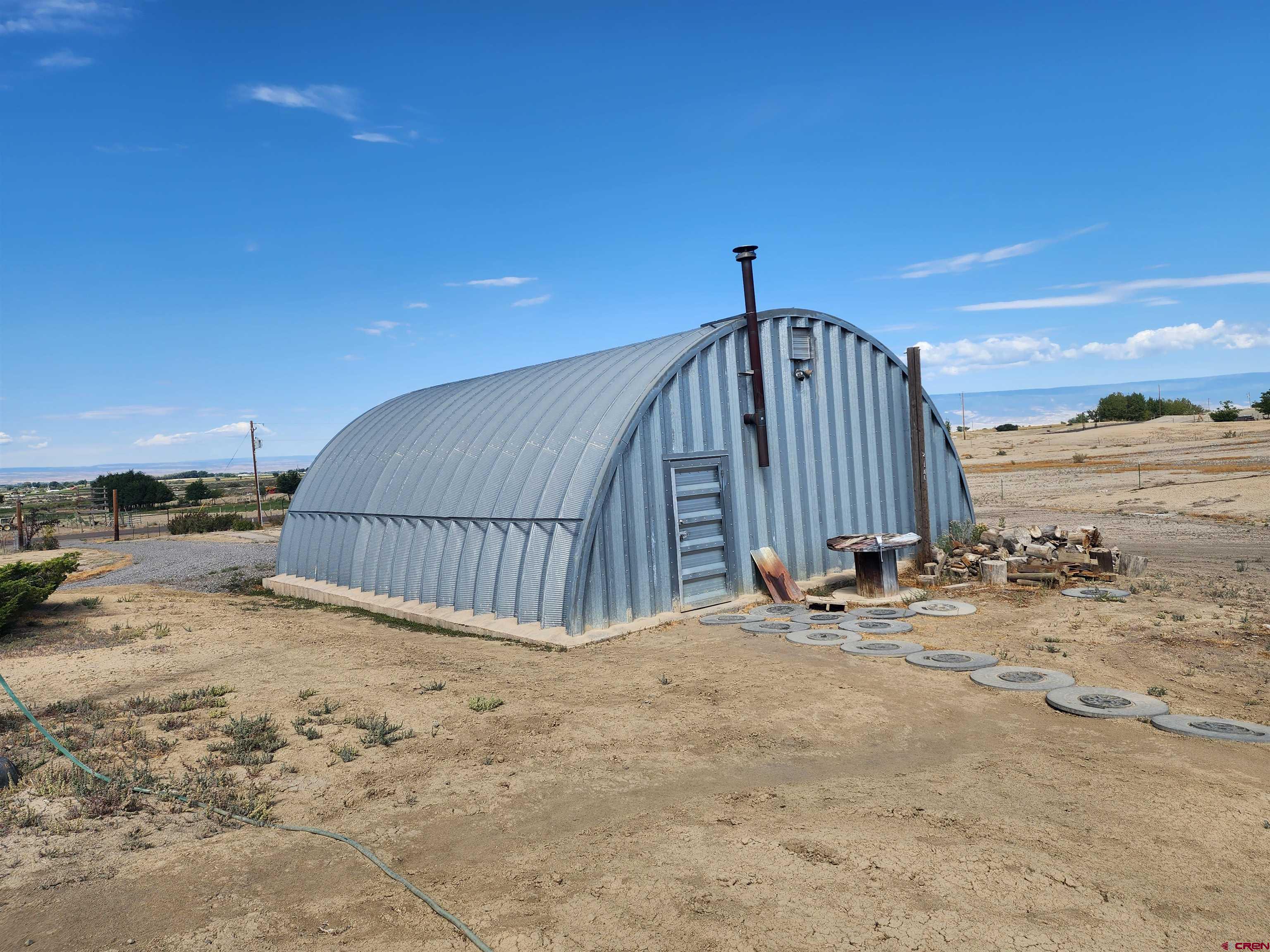 5280 6200th Road Olathe, CO 81425 - Photo 3 of 22 a view of a house with wooden fence
