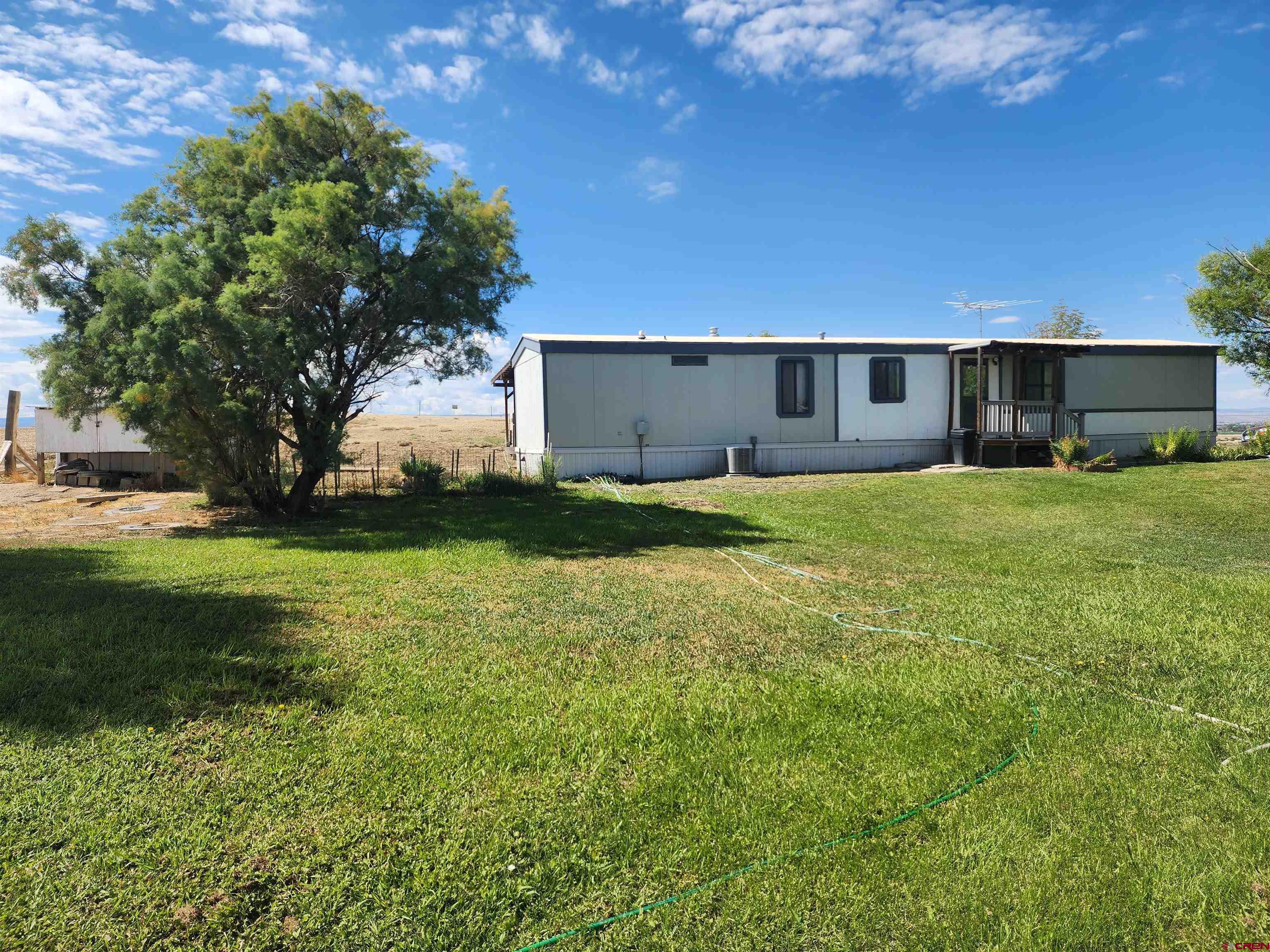 5280 6200th Road Olathe, CO 81425 - Photo 6 of 22 a house view with a sitting space and garden