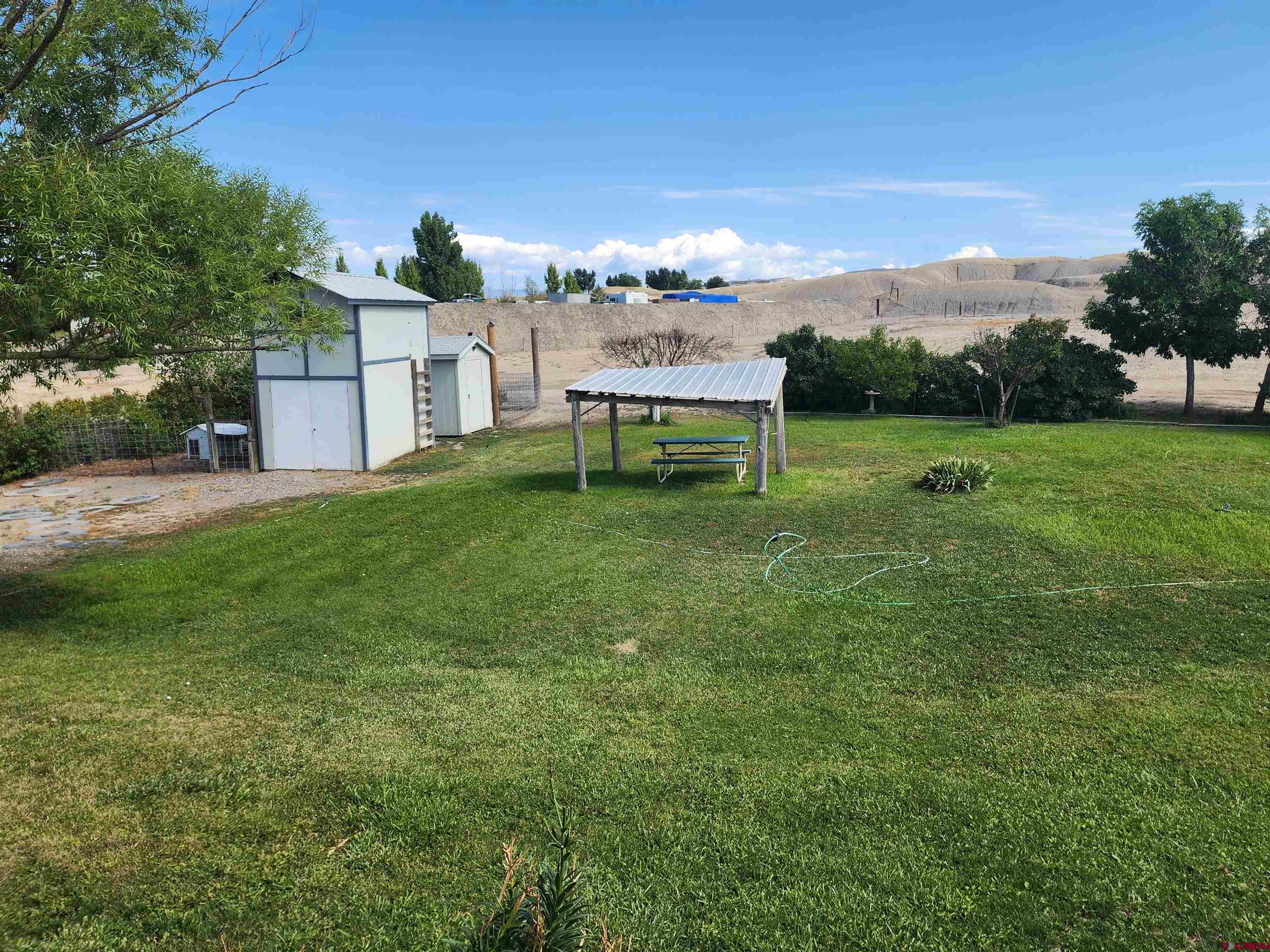 5280 6200th Road Olathe, CO 81425 - Photo 9 of 22 a view of a house with a yard porch and sitting area