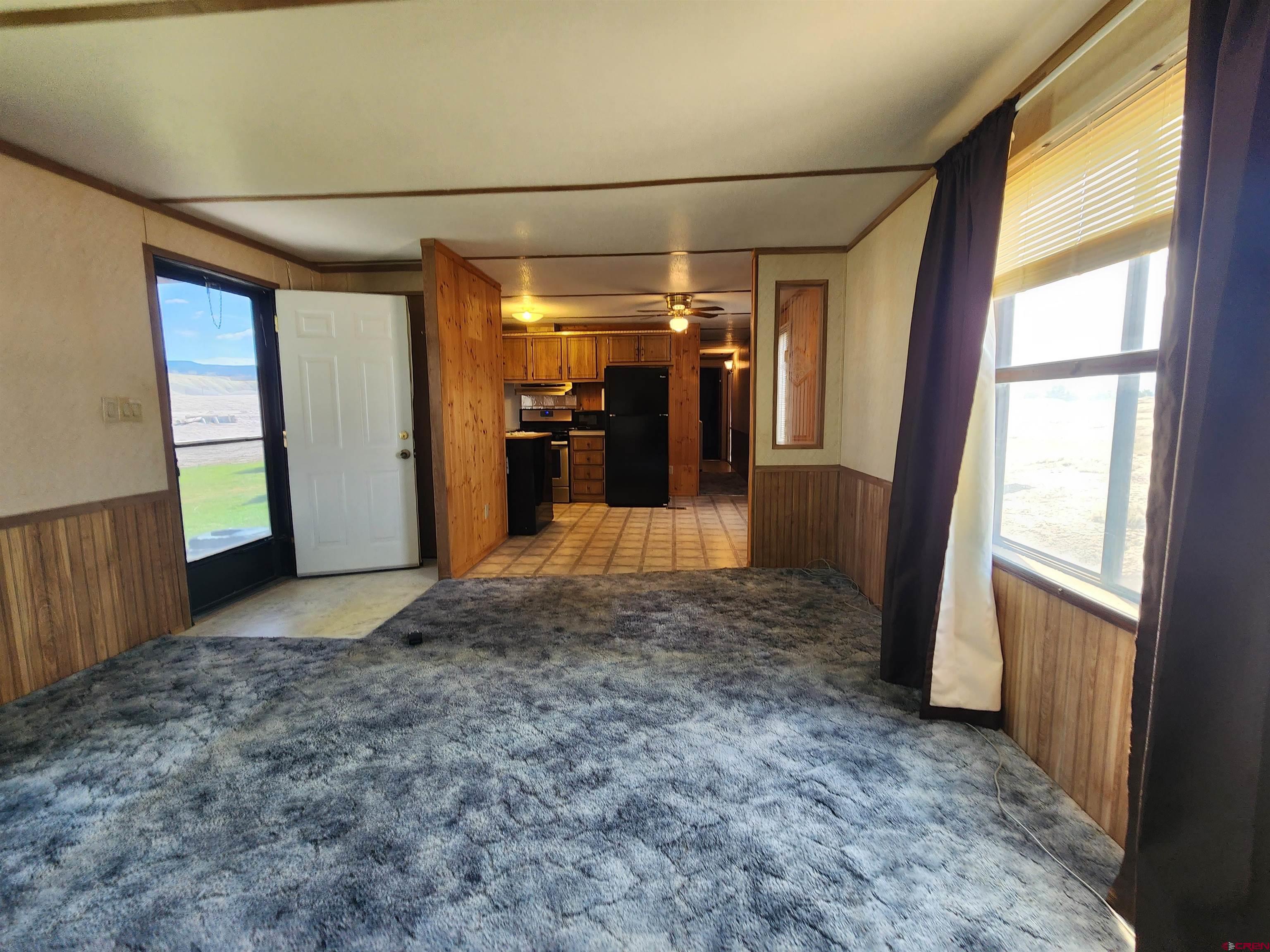 5280 6200th Road Olathe, CO 81425 - Photo 10 of 22 a view of a hallway with wooden shelves
