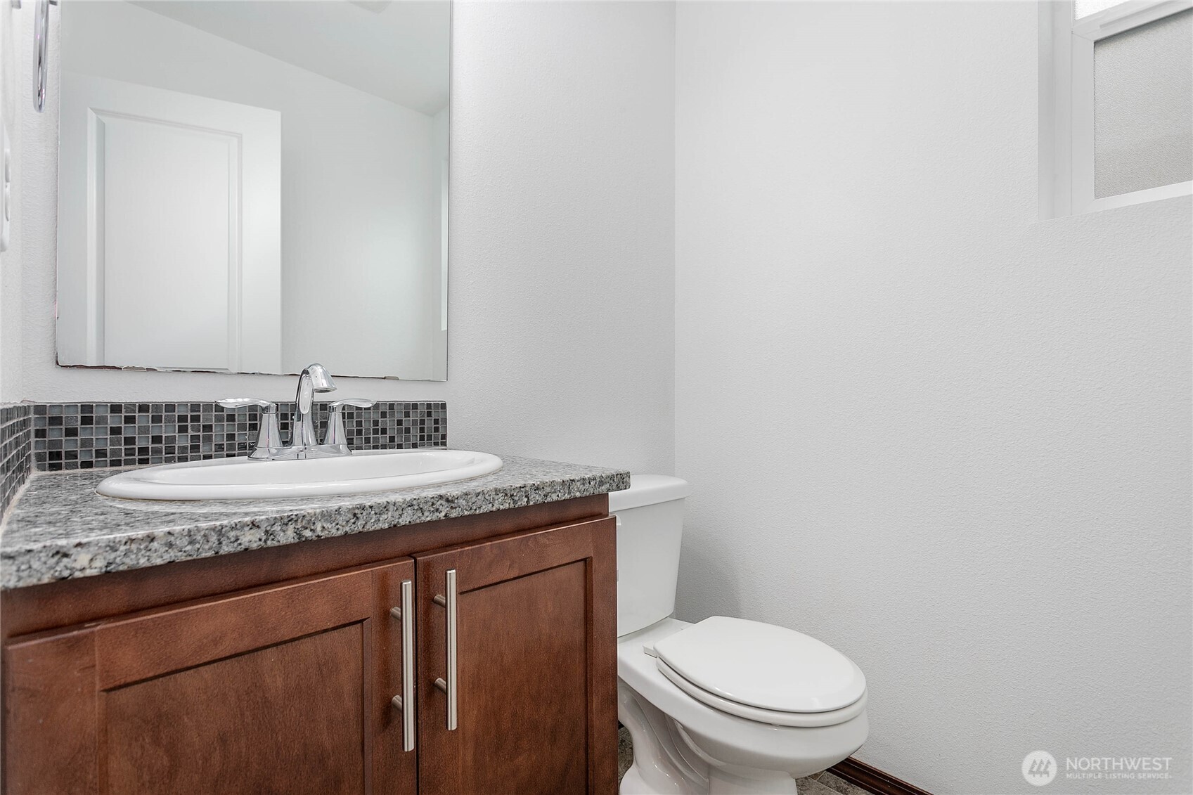 4305 Sumac Lane Bellingham, WA 98226 - Photo 12 of 38 a bathroom with a granite countertop sink a toilet and a mirror