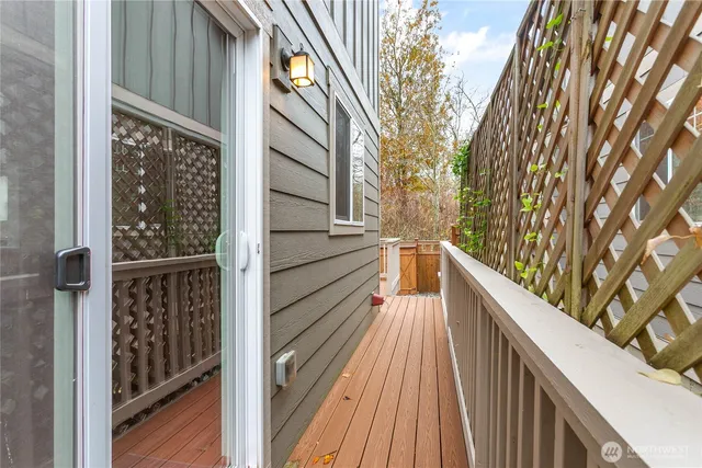 a view of a house with backyard and wooden fence