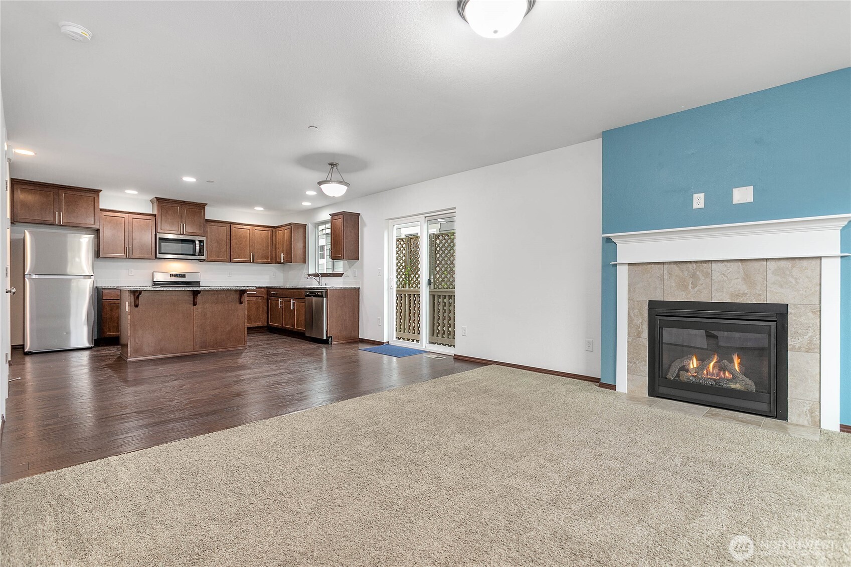 4305 Sumac Lane Bellingham, WA 98226 - Photo 7 of 38 a view of a kitchen with a sink a fireplace and a window