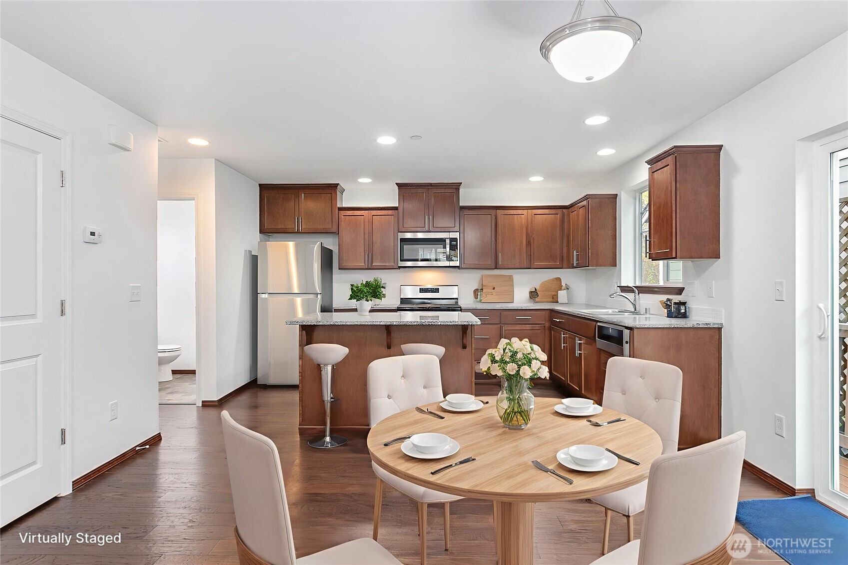 4305 Sumac Lane Bellingham, WA 98226 - Photo 8 of 38 a kitchen with stainless steel appliances granite countertop a stove a refrigerator a kitchen island a dining table and chairs