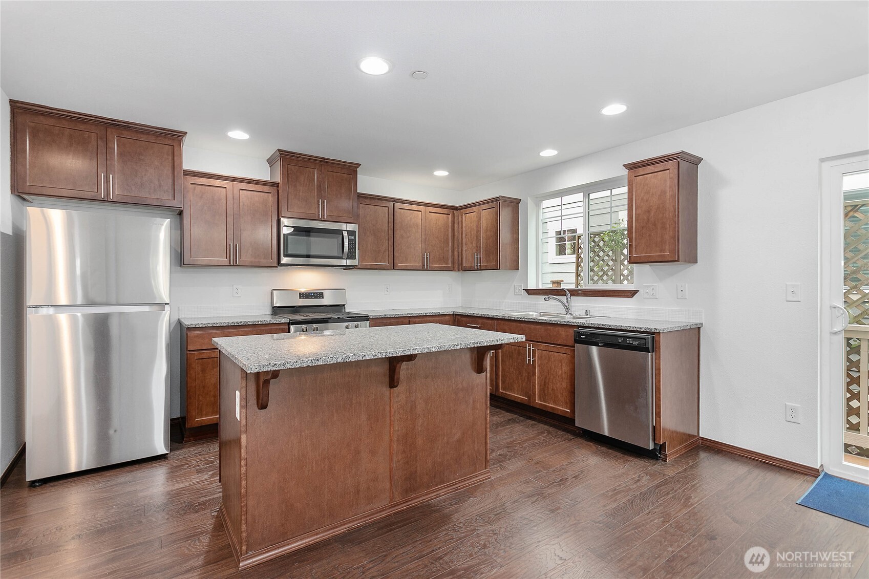 4305 Sumac Lane Bellingham, WA 98226 - Photo 10 of 38 a kitchen with stainless steel appliances granite countertop a refrigerator a stove a sink and a microwave