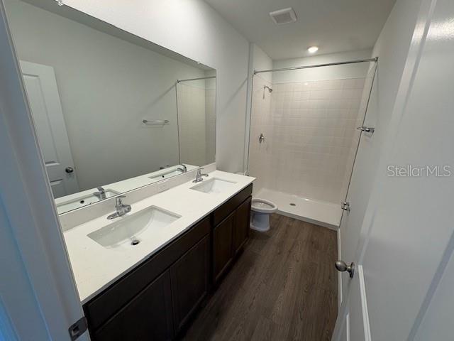 32547 Welling Blade Loop Wesley Chapel, FL 33545 - Photo 12 of 21 a bathroom with a double vanity sink a toilet and shower