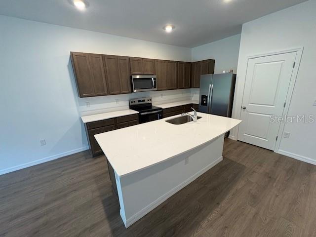 32547 Welling Blade Loop Wesley Chapel, FL 33545 - Photo 4 of 21 a living room with stainless steel appliances wooden floor table and chairs