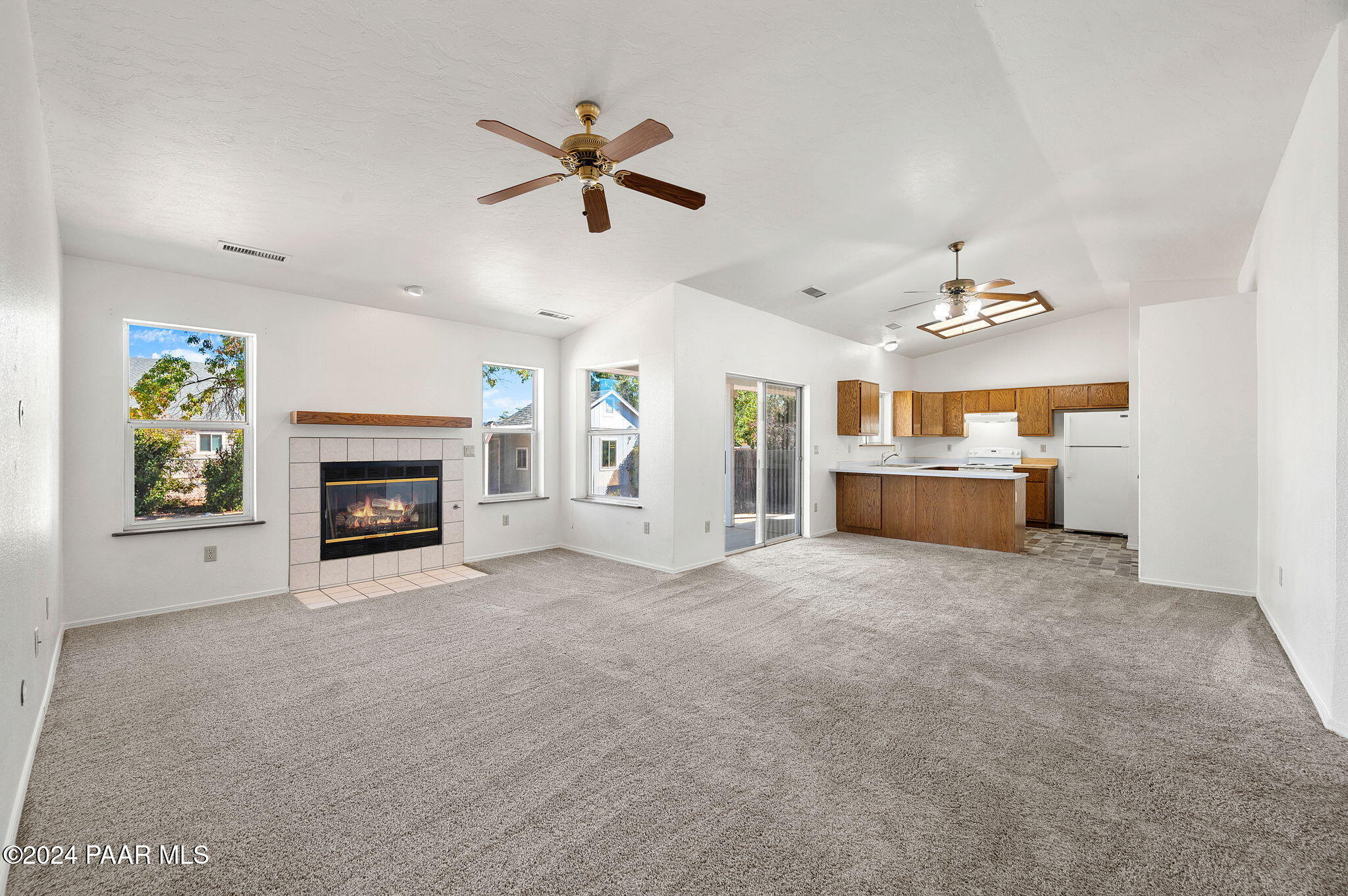 8128 East Gale Road Prescott Valley, AZ 86314 - Photo 11 of 38 a view of a livingroom with a fireplace and a ceiling fan