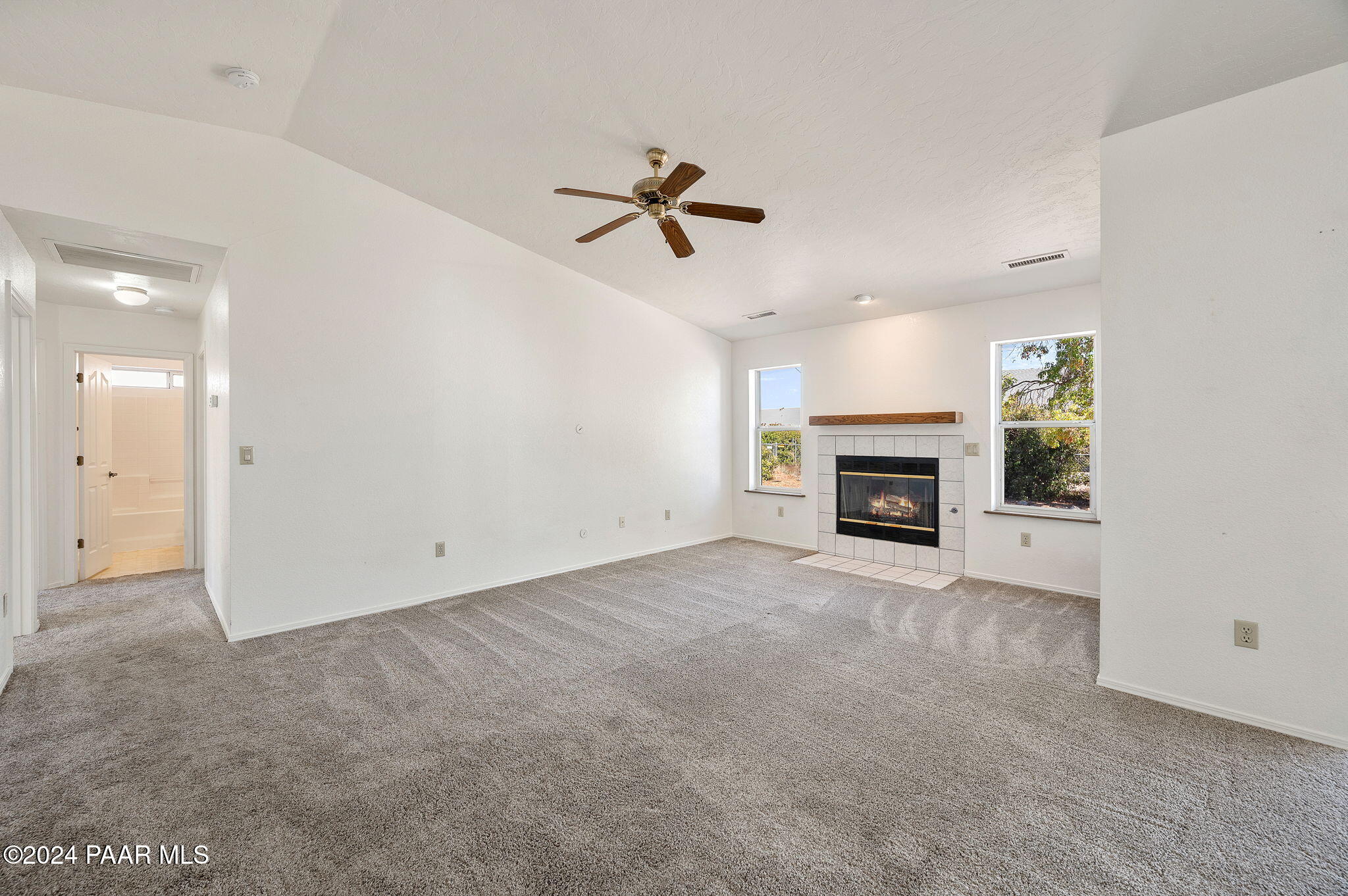 8128 East Gale Road Prescott Valley, AZ 86314 - Photo 12 of 38 an empty room with fireplace and ceiling fan