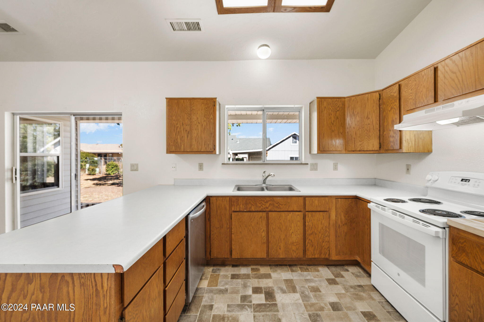 8128 East Gale Road Prescott Valley, AZ 86314 - Photo 13 of 38 a kitchen with stainless steel appliances a sink stove and cabinets