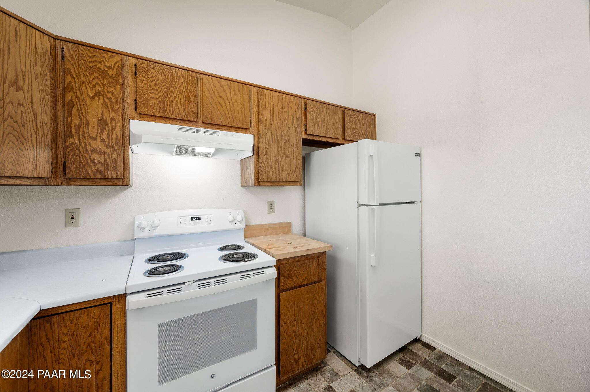 8128 East Gale Road Prescott Valley, AZ 86314 - Photo 16 of 38 a kitchen with a refrigerator and a stove top oven