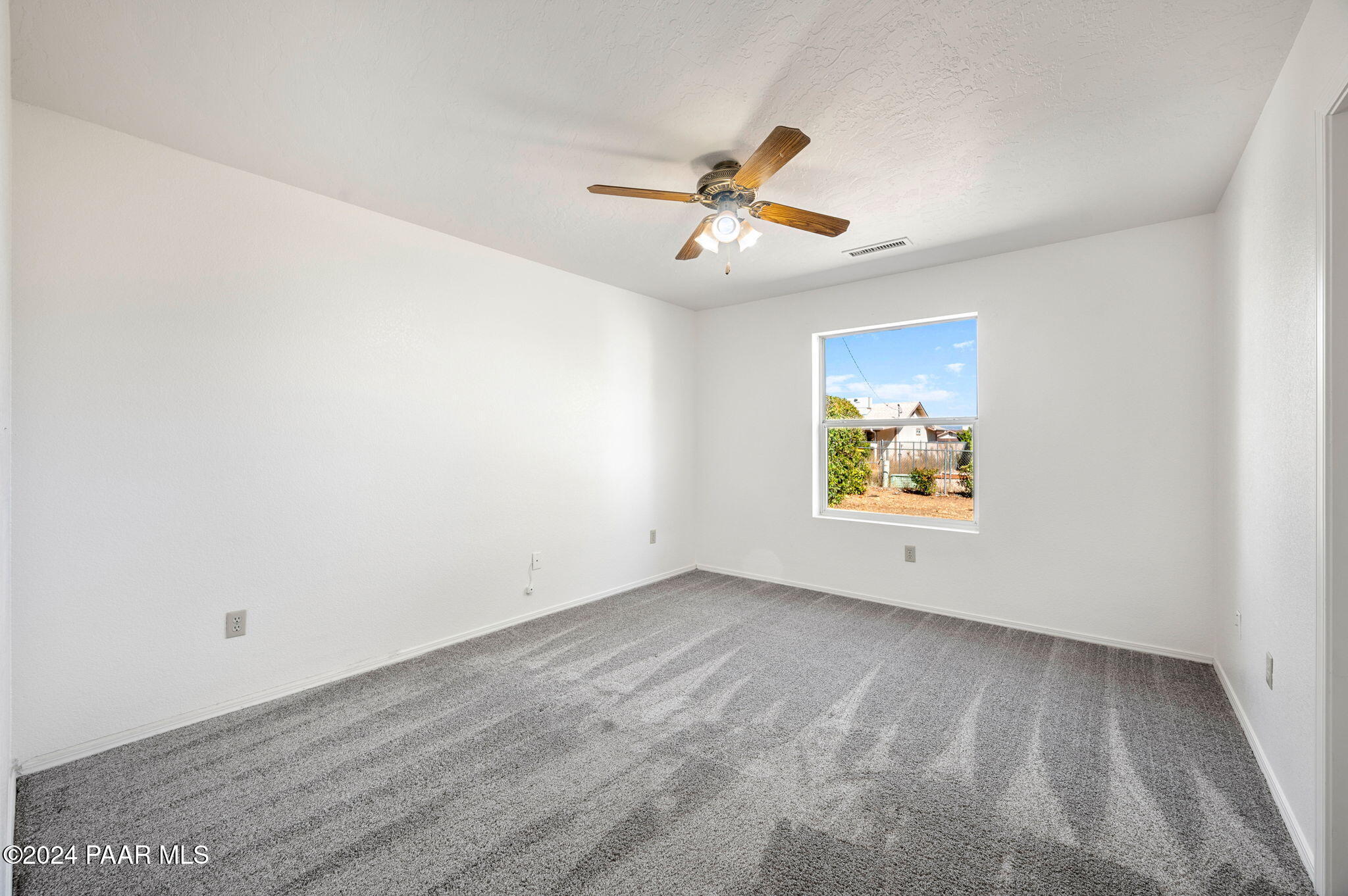 8128 East Gale Road Prescott Valley, AZ 86314 - Photo 20 of 38 an empty room with windows and fan