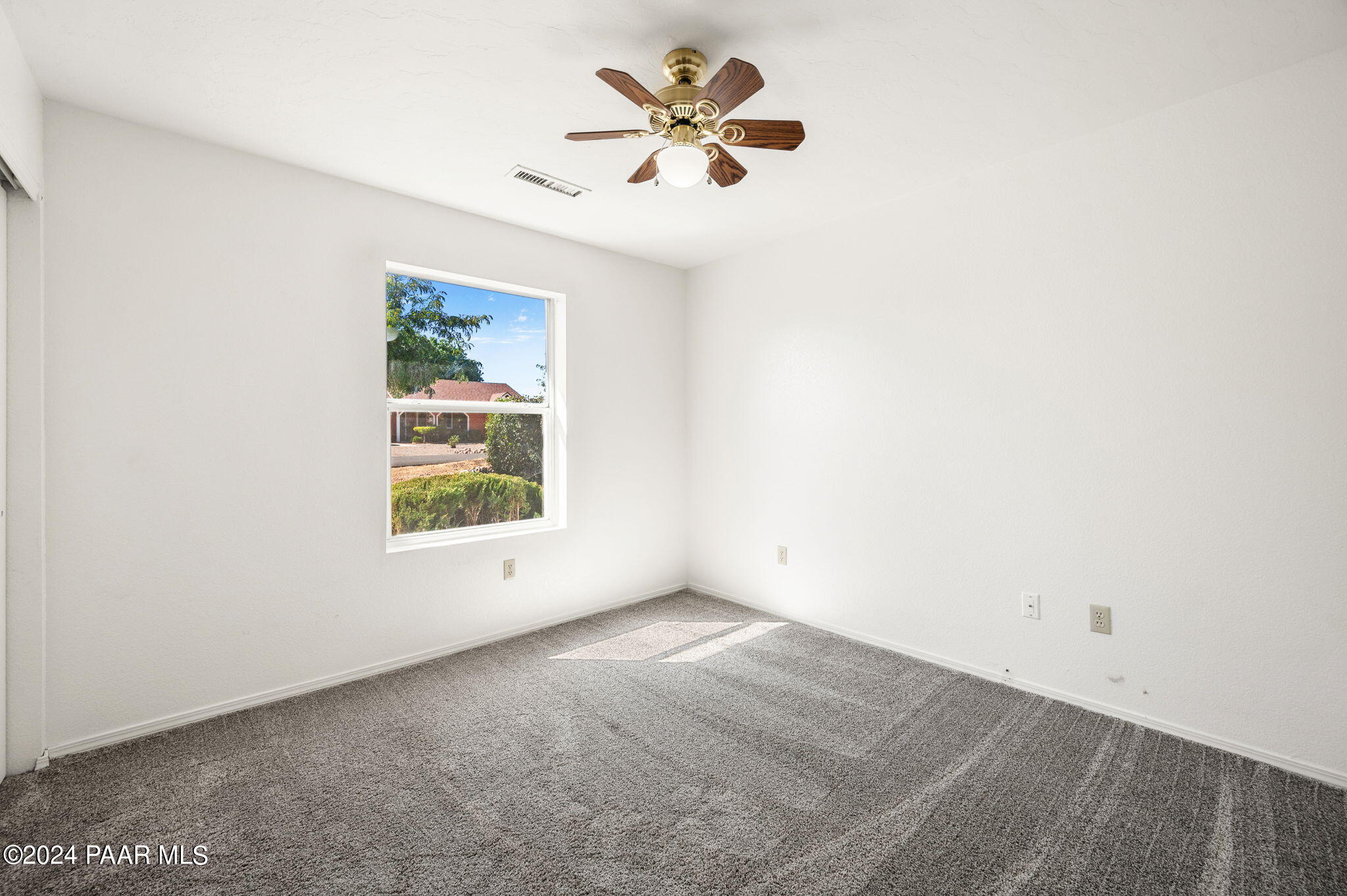 8128 East Gale Road Prescott Valley, AZ 86314 - Photo 23 of 38 an empty room with a window and a fan