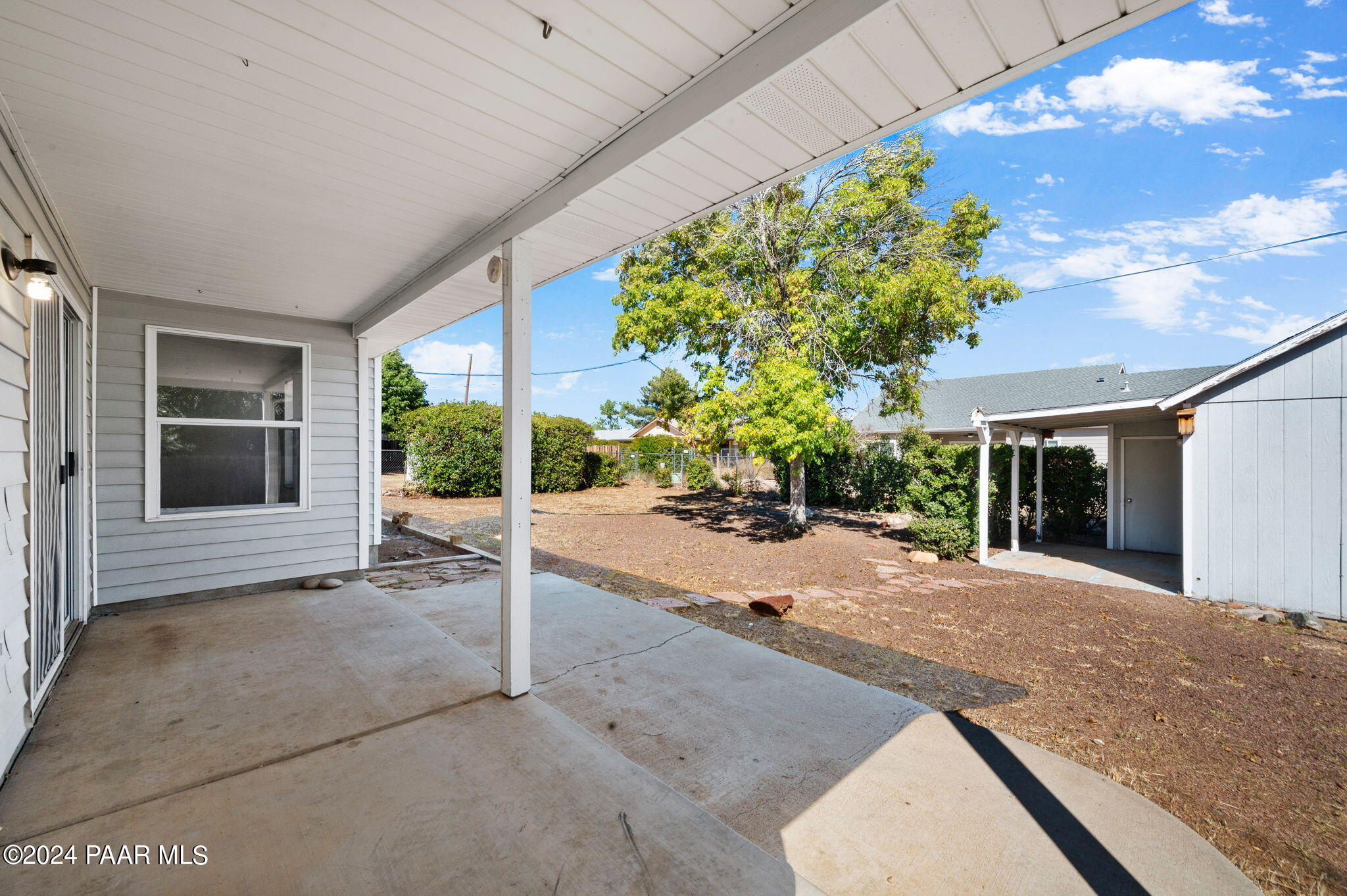 8128 East Gale Road Prescott Valley, AZ 86314 - Photo 28 of 38 a porch with a table and chairs and potted plants