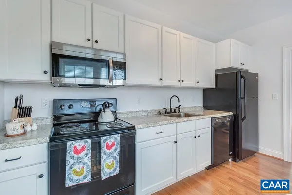a kitchen with stainless steel appliances granite countertop a stove and cabinets