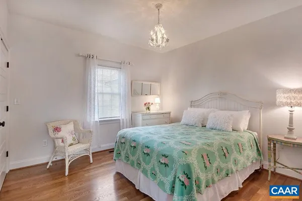 a bedroom with a bed and a chair