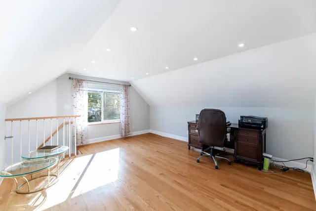 a view of workspace with wooden floor and windows