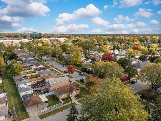 an aerial view of residential building with green space
