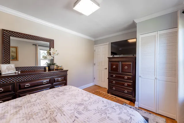 a bedroom with a bed and a television