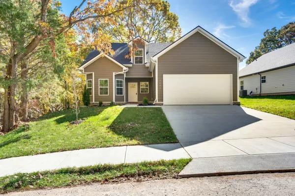 a front view of a house with a yard and garage