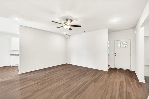 wooden floor in an empty room with a window