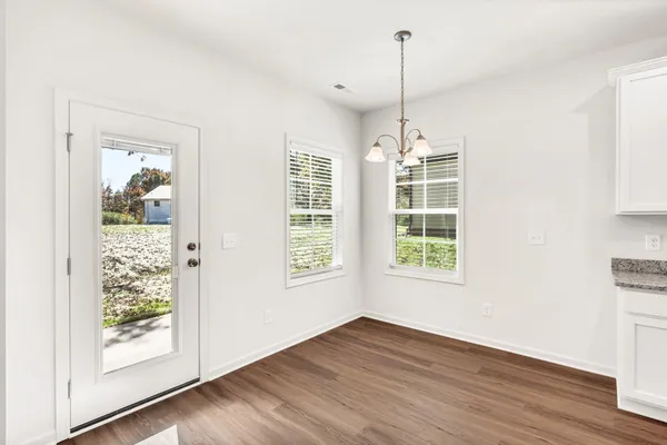 a kitchen with a wooden floor and window