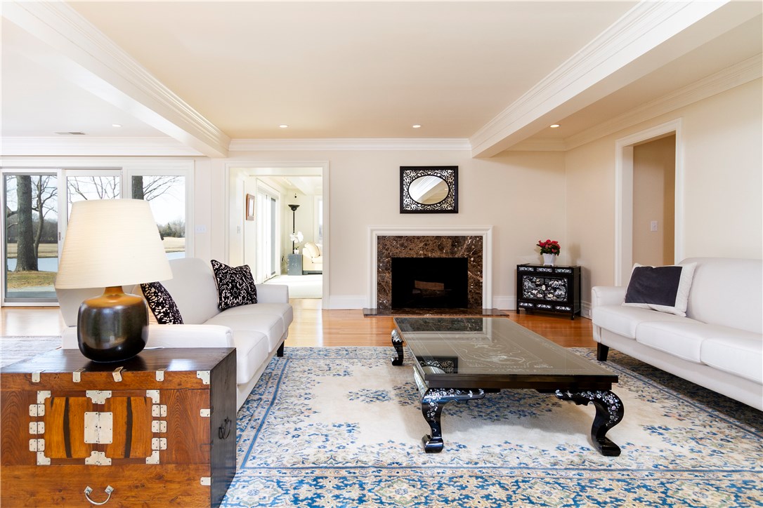 25 Pojac Point Road North Kingstown, RI 02852 - Photo 7 of 40 Living room complemented by a marble wood burning fireplace.