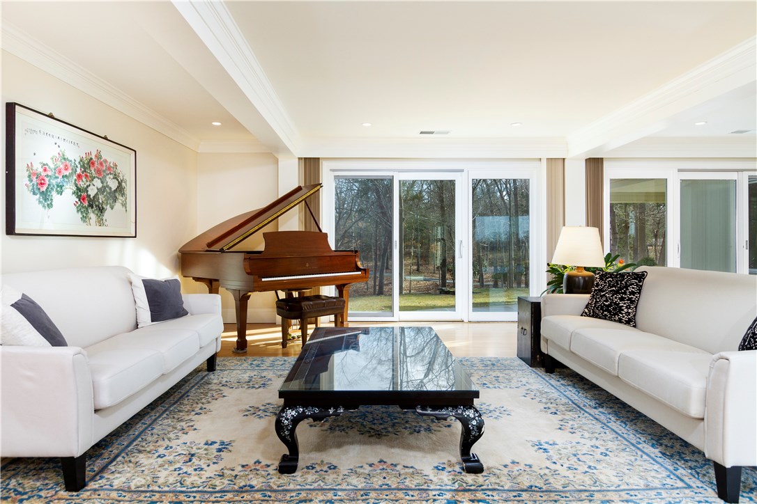 25 Pojac Point Road North Kingstown, RI 02852 - Photo 8 of 40 Two, 3 paneled sliders lead to a blue stone patio and offer views of the wooded rolling topography.