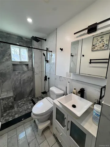 a bathroom with a sink toilet and shower