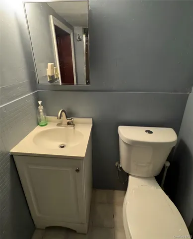 a bathroom with a toilet sink and mirror