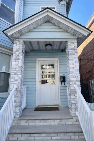 a front view of a house with white door