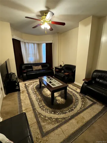 a living room with furniture pool table and a window