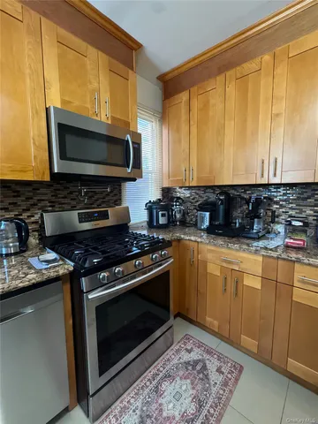 a kitchen with stainless steel appliances a stove a sink and a microwave