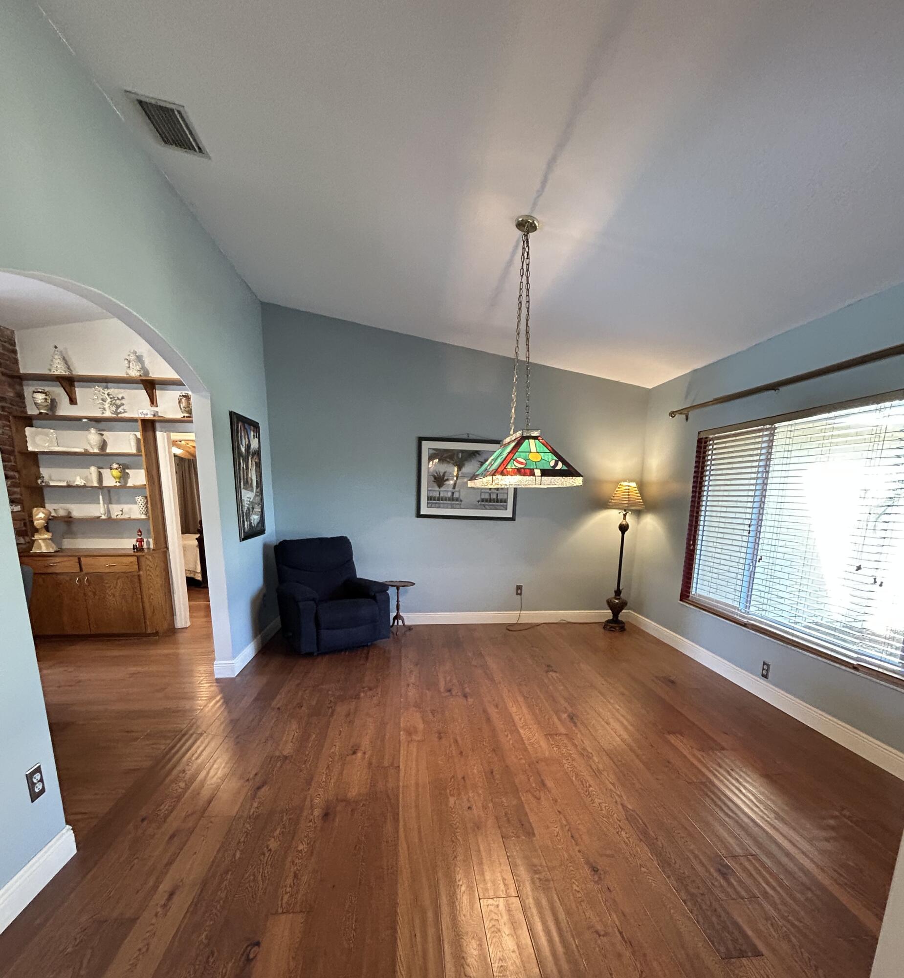 4422 Brandywine Drive Boca Raton, FL 33487 - Photo 3 of 18 a living room with a bed furniture and a large window