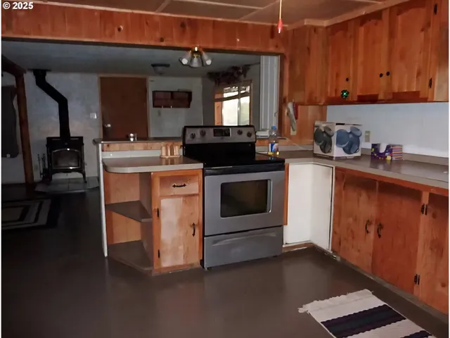 a kitchen with a refrigerator and window