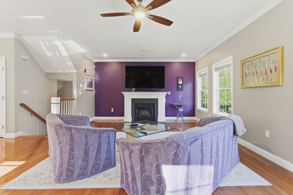 66 Compass Point, Unit 66 North Andover, MA 01845 - Photo 21 of 42 a living room with furniture a flat screen tv and a fireplace