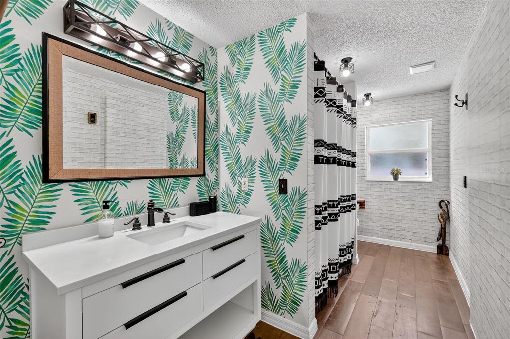 14520 Lost Lake Road Clermont, FL 34711 - Photo 25 of 47 a bathroom with a sink vanity granite and a mirror
