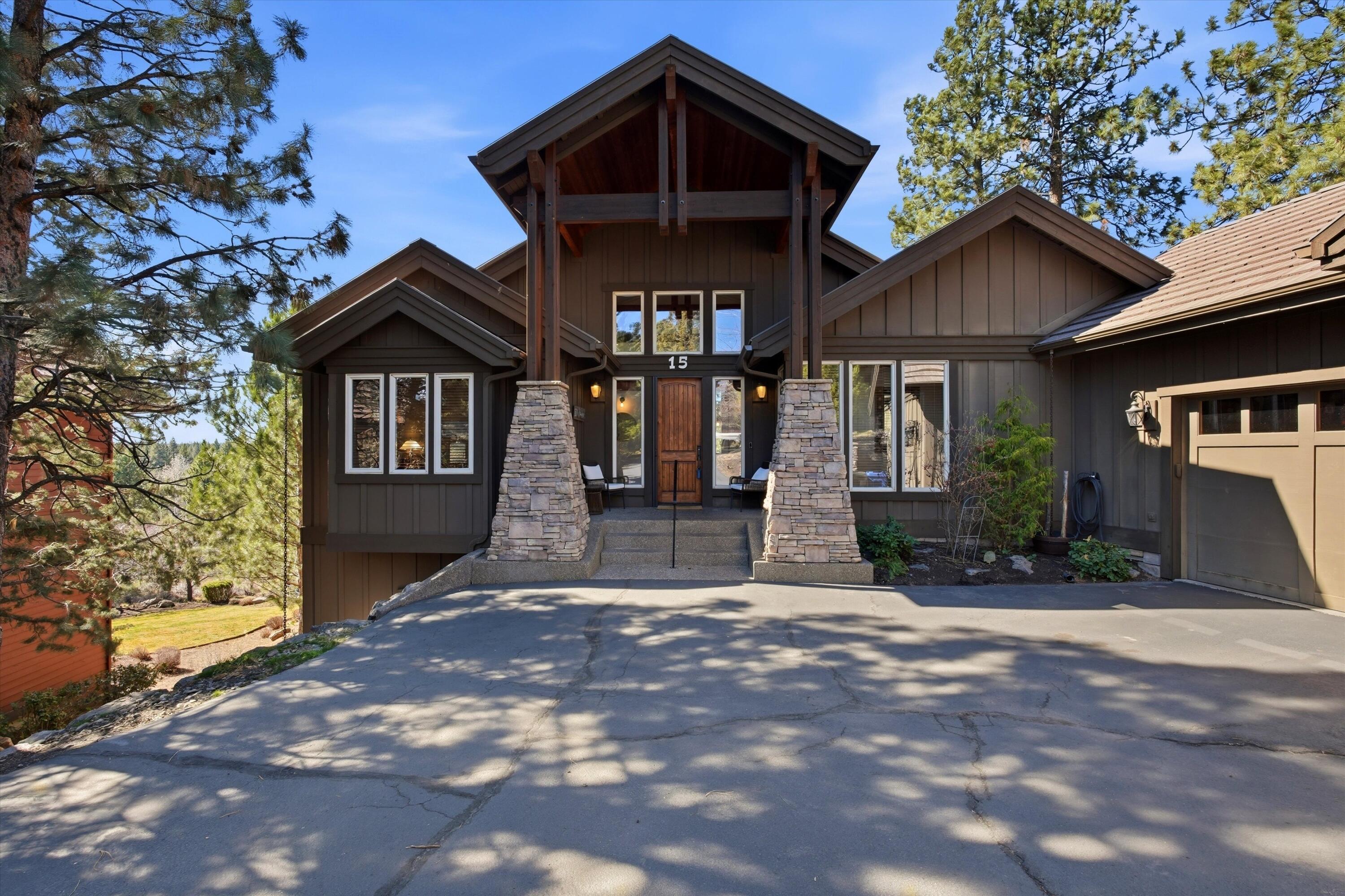 15 Southwest Quail Butte Place Bend, OR 97703 - Photo 46 of 55 a front view of a house with yard