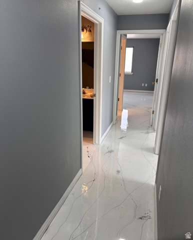 8116 North Ridge Loop West, Unit 8 Eagle Mountain, UT 84005 - Photo 1 of 23 Hall featuring baseboards and light marble finish floors