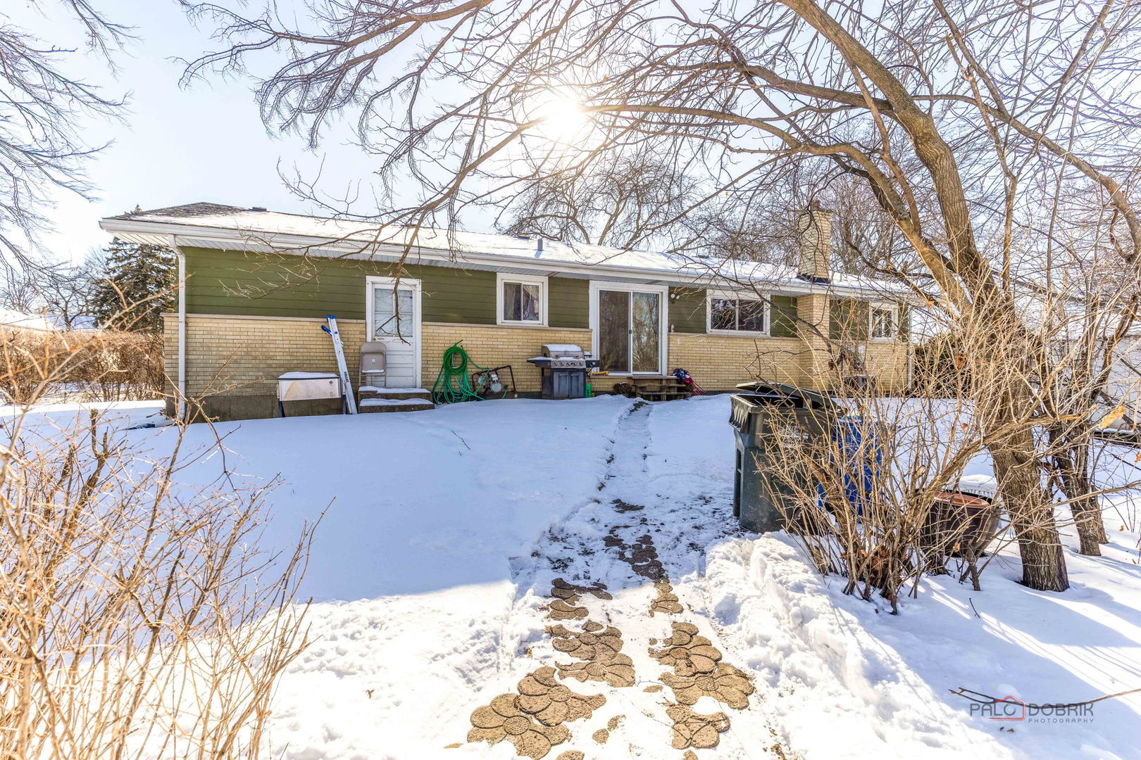908 East Central Road Mount Prospect, IL 60056 - Photo 25 of 25 a front view of a house with a yard covered in snow