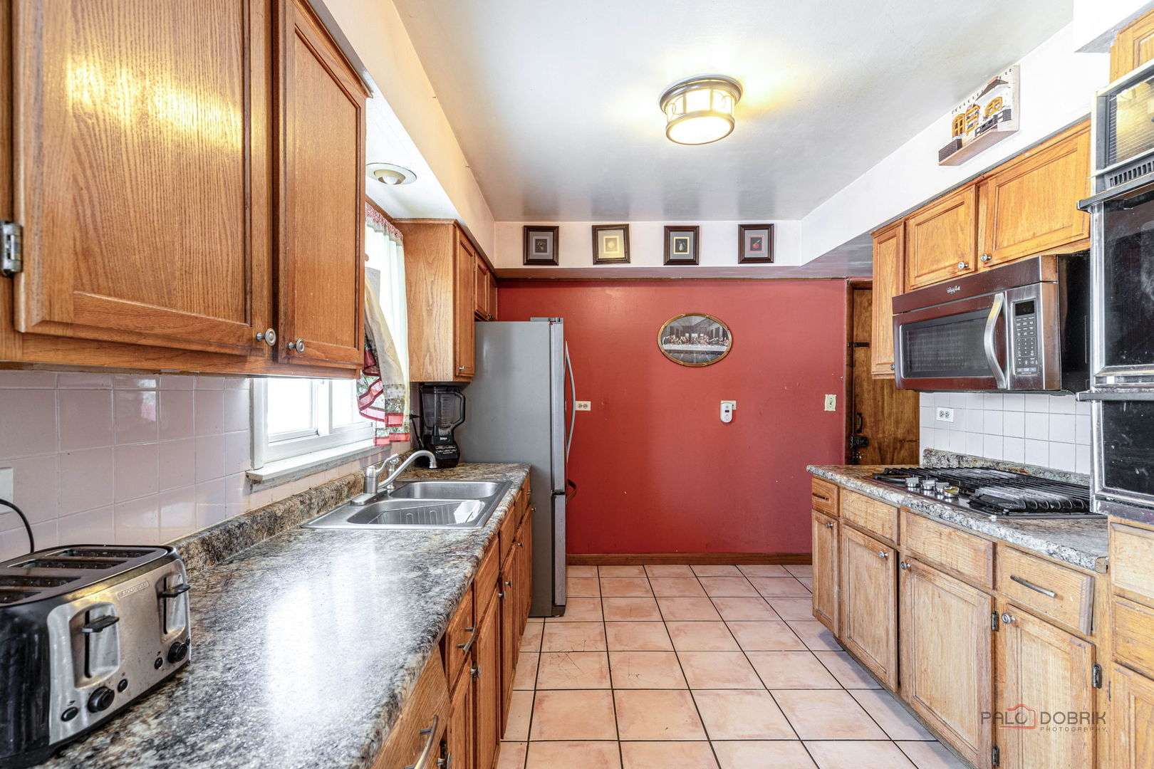 908 East Central Road Mount Prospect, IL 60056 - Photo 8 of 25 a kitchen with stainless steel appliances granite countertop a stove a sink and a microwave