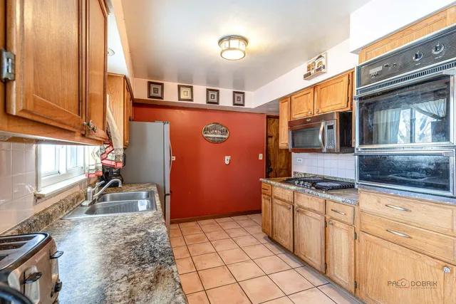 a kitchen with stainless steel appliances granite countertop a stove and a sink