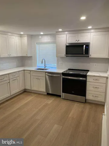 a kitchen with stainless steel appliances granite countertop a stove and a sink