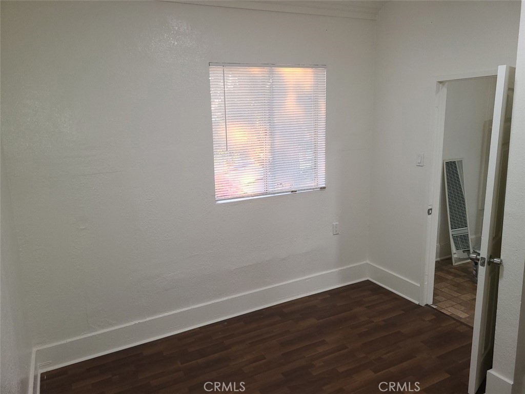 127 North Burlington Avenue, Unit C Los Angeles, CA 90026 - Photo 2 of 8 an empty room with wooden floor and a window