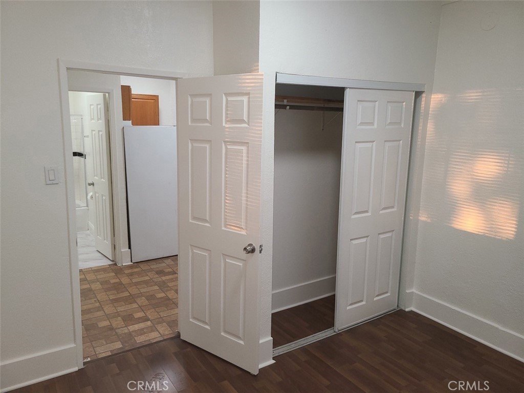 127 North Burlington Avenue, Unit C Los Angeles, CA 90026 - Photo 3 of 8 an empty room with wooden floor and closet