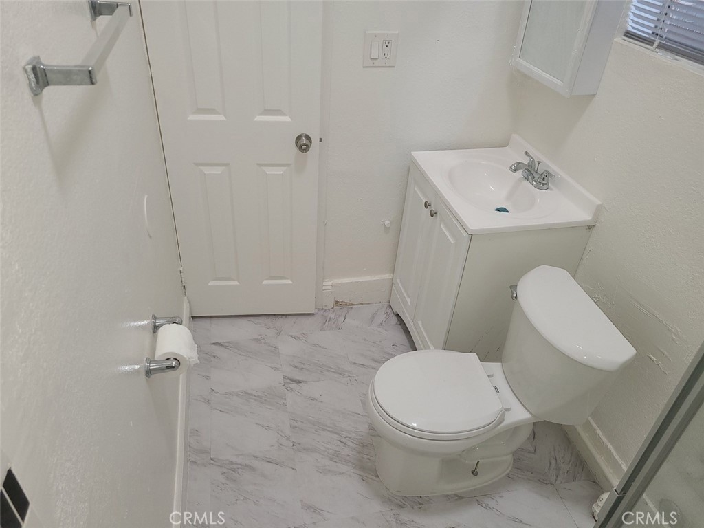 127 North Burlington Avenue, Unit C Los Angeles, CA 90026 - Photo 4 of 8 a white toilet sitting next to a bathroom sink