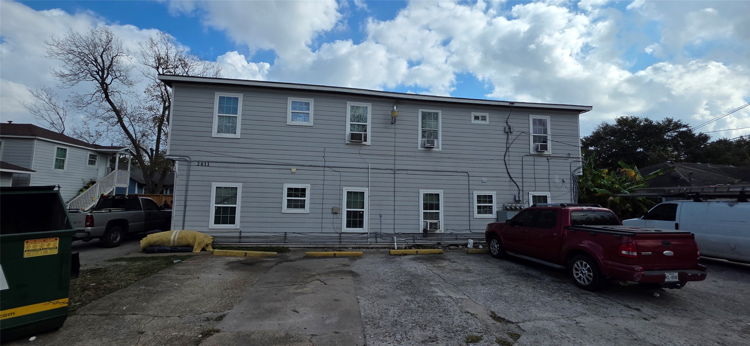 a couple of cars parked in front of a house
