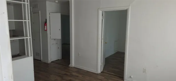 a view of hallway with wooden floor