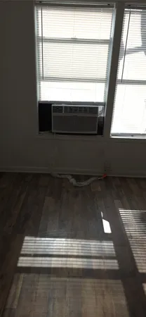 a kitchen with granite countertop a refrigerator and a stove top oven